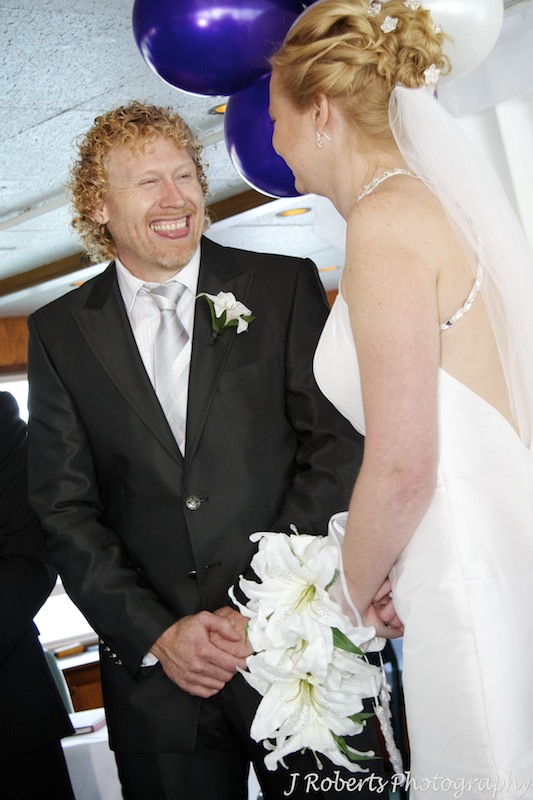 Groom laughing during wedding ceremony - wedding photography